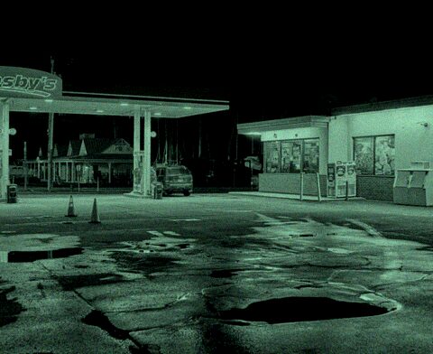 dvrbridge DVR channel 4 — night CCTV camera view of a storefront